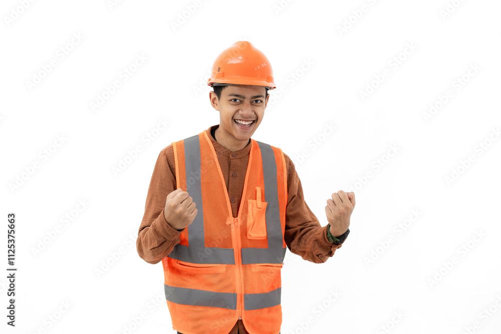 Energetic young Indonesian male construction worker standing with his fists clenched, industrial and construction concept, isolated white background. Energetic young Indonesian male construction worker standing with his fists clenched, industrial and construction concept, isolated white background.