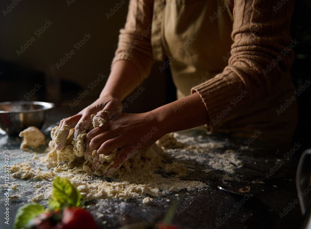 Person kneading fresh dough on a floured surface in a cozy kitchen Person kneading fresh dough on a floured surface in a cozy kitchen