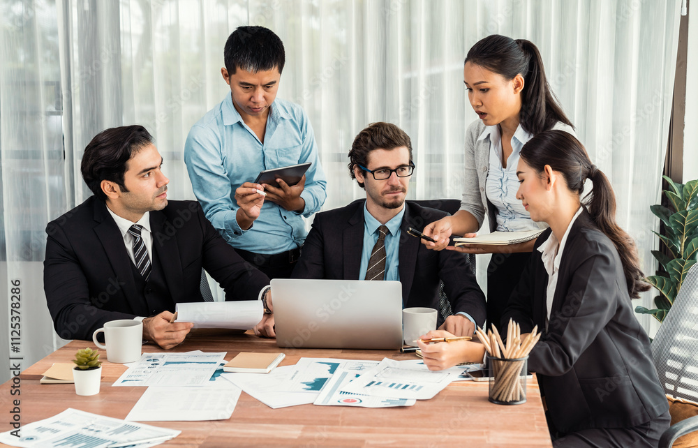 Diverse group of business analyst team analyzing financial data report paper on office table. Chart and graph dashboard by business intelligence analysis for strategic marketing planning Meticulous Diverse group of business analyst team analyzing financial data report paper on office table. Chart and graph dashboard by business intelligence analysis for strategic marketing planning Meticulous