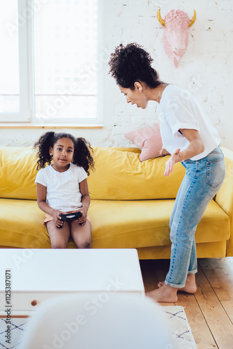 Photography Parent reprehending kid with joystick