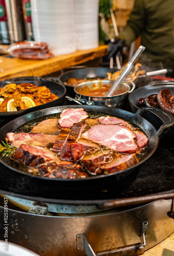 Traditional Christmas Market Food: Sausages and Meat Cooking in a Pan. photo