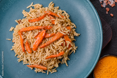 Delicious fresh pilaf with rice, carrots, meat, onions, spices and berries