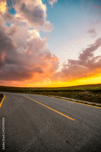 Sunset on Romania Transalpina road with many serpentines crossing forest in  Carpathian mountains. Mountains forest trees with road in Parang mountains