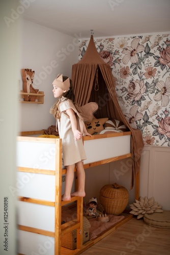 little girl in the children's room on the bed photo