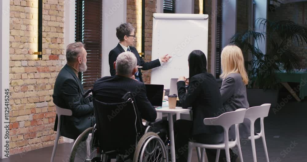 Businesswoman stands by whiteboard pointing to growth chart Businesswoman stands by whiteboard pointing to growth chart