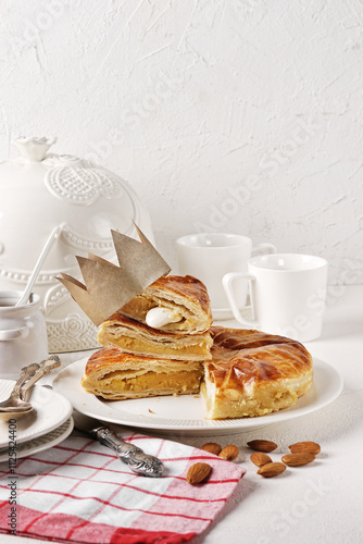 King cake or galette des rois in French. Traditional epiphany pie with golden paper crown and tiny charms