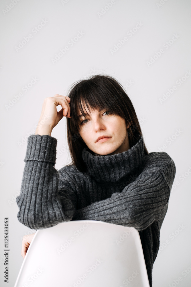 Young woman smiling in cozy sweater, casual winter fashion, minimalist style, warm and comfortable, positive energy, relaxed indoor portrait. Young woman smiling in cozy sweater, casual winter fashion, minimalist style, warm and comfortable, positive energy, relaxed indoor portrait.