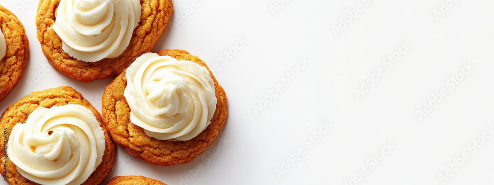 Delicious vanilla-frosted cookies arranged on a white surface, showcasing their tempting swirls and golden texture. Delicious vanilla-frosted cookies arranged on a white surface, showcasing their tempting swirls and golden texture.