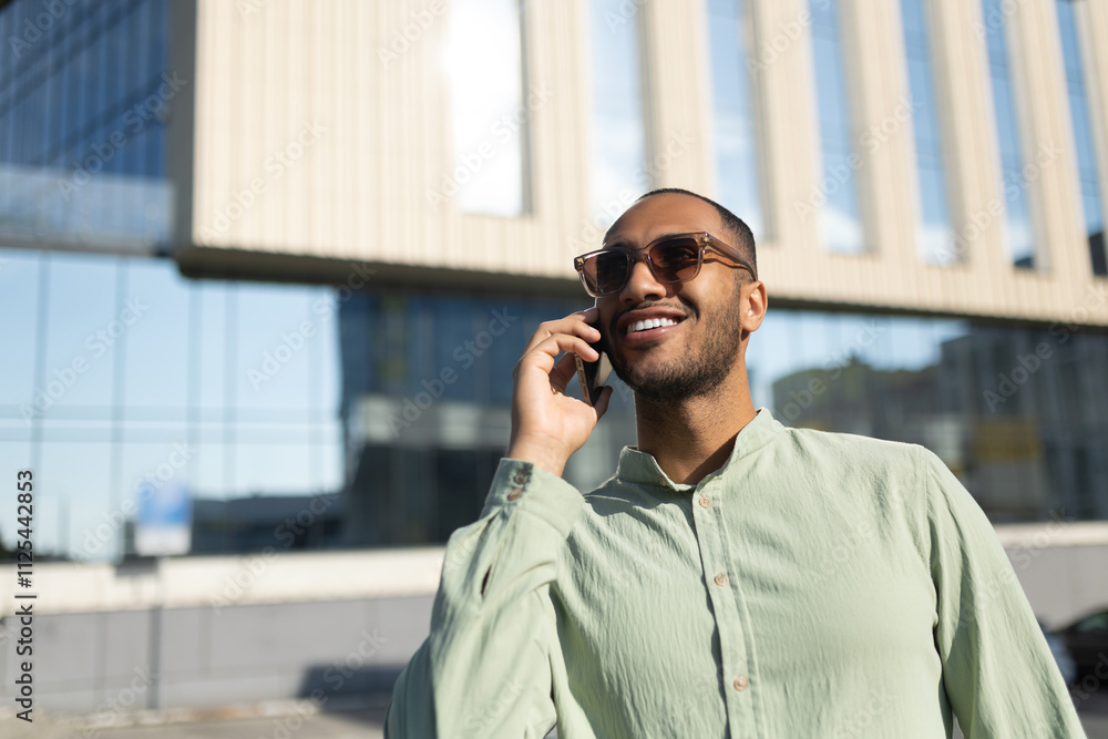African American man having cell phone call outdoor in city street African American man having cell phone call outdoor in city street
