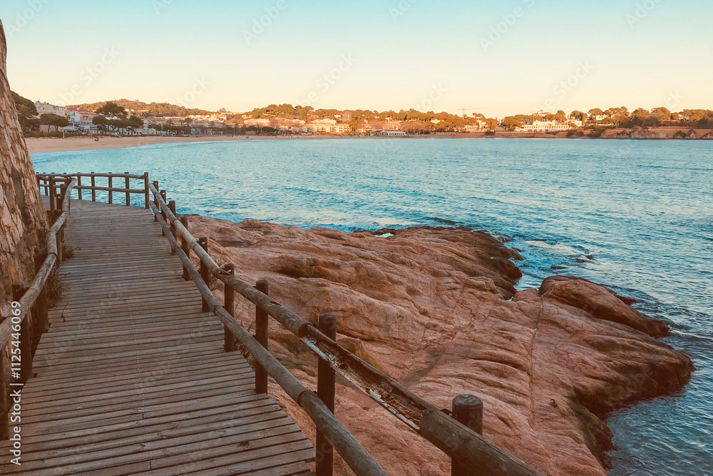 Fototapeta premium Wooden Boardwalk by the Scenic Rocky Coastline