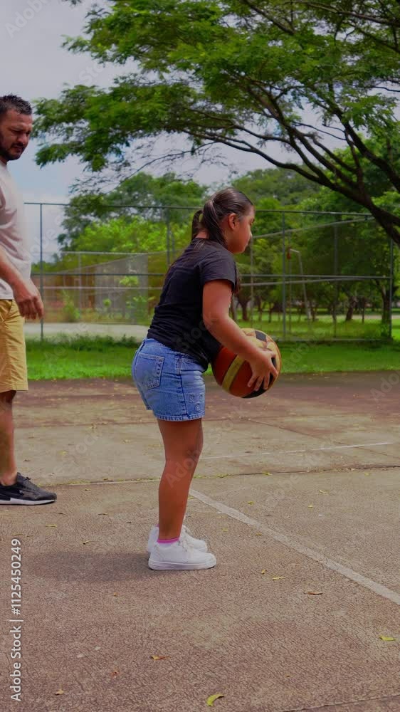 Video of girl with Down syndrome running and throwing the ball into the basket Video of girl with Down syndrome running and throwing the ball into the basket