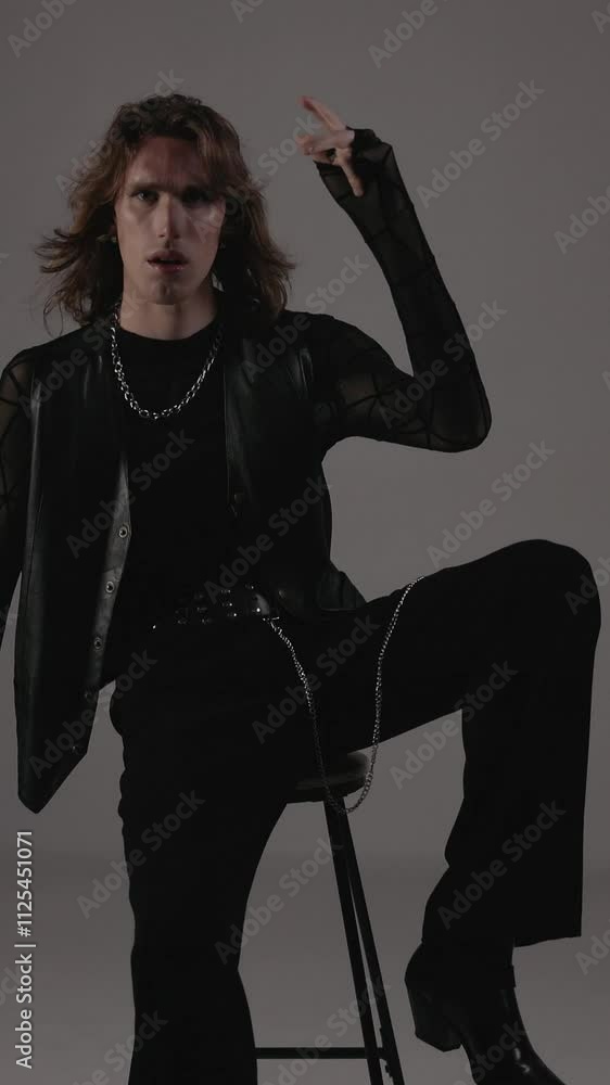 Stylish Male Model On Chair In Studio. Stylish Male Model On Chair In Studio.