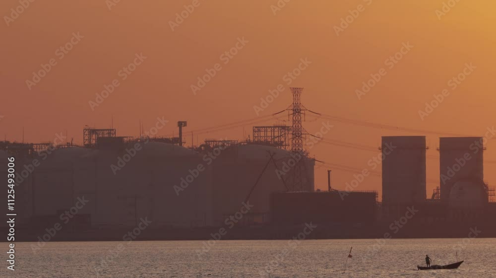 Smokestack emits smoke from power plant, silhouetted against sunset sky. This industrial skyline shows the environmental impact of fossil fuel for air pollution, carbon emissions, and climate change. Smokestack emits smoke from power plant, silhouetted against sunset sky. This industrial skyline shows the environmental impact of fossil fuel for air pollution, carbon emissions, and climate change.