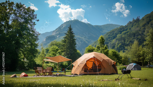 big brown dome camping tent in a green grass with trees and mountains. Taken in an afternoon with a clear blue sky with white clouds. There're chairs, table and camping equipments nearby