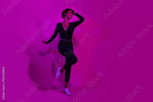 Full body photo of attractive young woman dancing posing model wear trendy overall clothes isolated on neon light pink color background