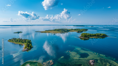 Scenic aerial view of serene lake with cloud reflections and lush green islands