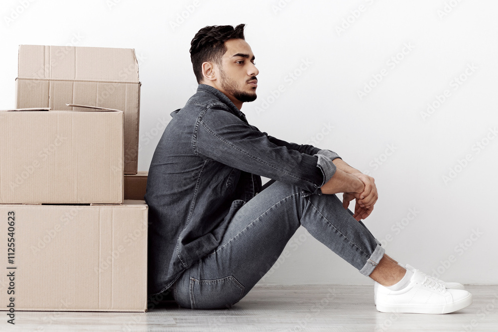 Upset arab family sitting separated by boxes on floor in empty apartment, having problem with relocating, white wall background, side view, copy space. Depressed middle-eastern couple at new home Upset arab family sitting separated by boxes on floor in empty apartment, having problem with relocating, white wall background, side view, copy space. Depressed middle-eastern couple at new home