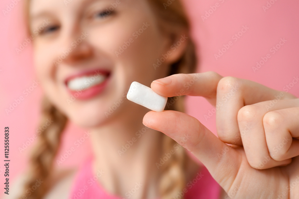 Teenage girl with chewing gum on pink background, closeup Teenage girl with chewing gum on pink background, closeup