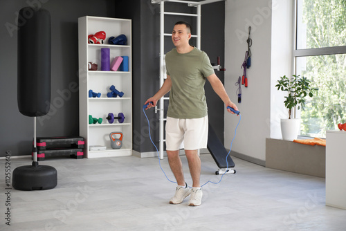 Sporty young man jumping wi...