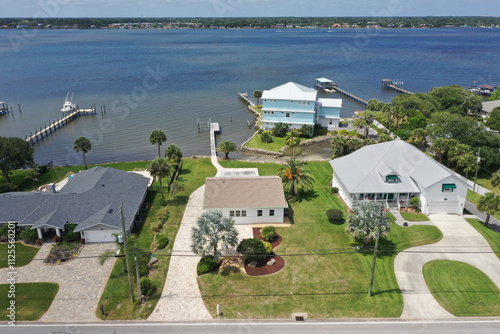 Aerial looking west over the Intracoastal Waterway ( Halifax River) and Daytona Beach Shores wealthy riverfront houses and boat docks.