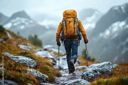 A person carrying a backpack ascends a hill, great for outdoor adventure or travel themes photo