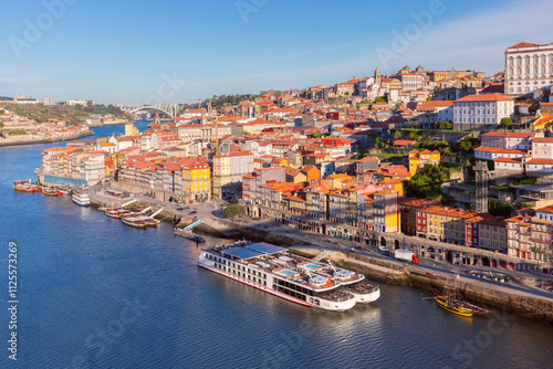 Douro River with colorful riverside buildings, traditional boats Porto, Portugal photo