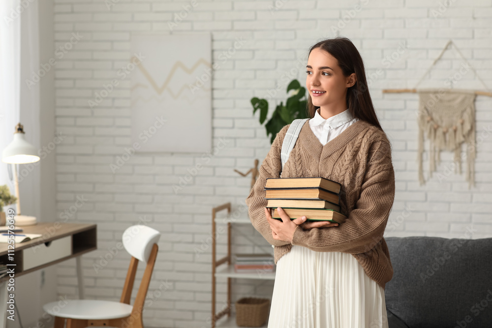 Beautiful happy female student with stack of books and backpack at home Beautiful happy female student with stack of books and backpack at home