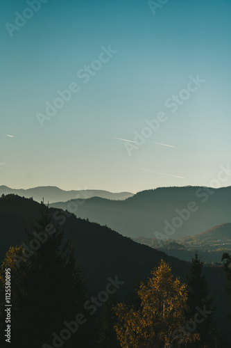 Sunsetting With Mountain Silhouette Shape. Big Beautiful Sunset Cloud Under The Mountains In A Haze.