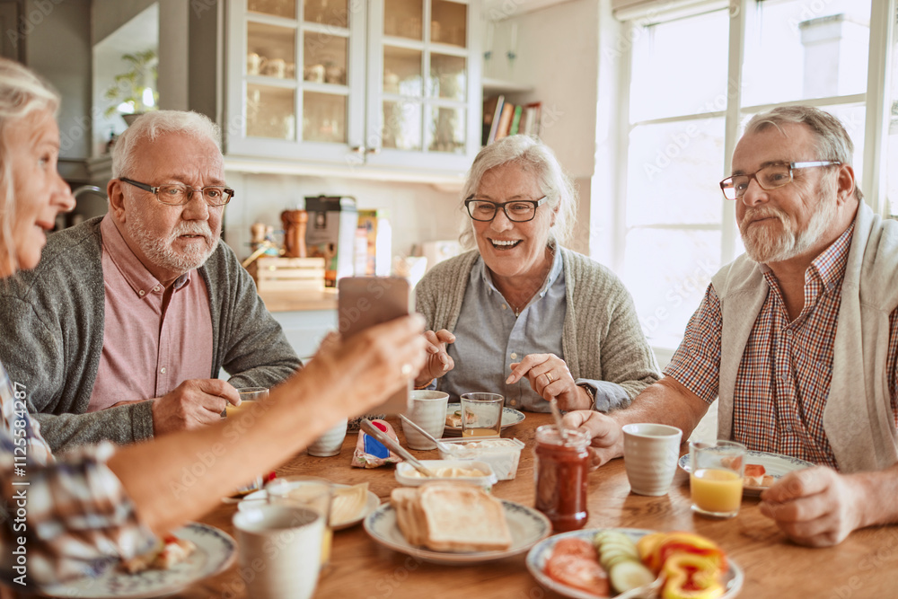 Senior friends enjoying breakfast together in a cozy kitchen Senior friends enjoying breakfast together in a cozy kitchen