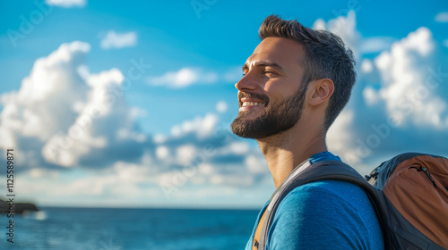 Young caucasian male adventurer enjoying a scenic beach hike under a clear blue sky