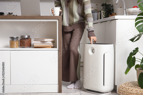 Young woman with air purifi...