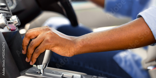 Car Driving Concept. Unrecognizable African American Male Driver Shifting To Drive Mode. Closeup Of Hand on Transmission Stick, Selective Focus. Riding Automobile