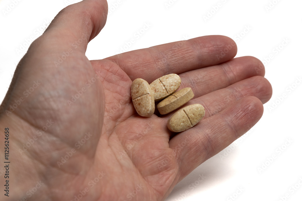 Drugs in a man hand isolated on white background. Tablets in a hand of human Drugs in a man hand isolated on white background. Tablets in a hand of human