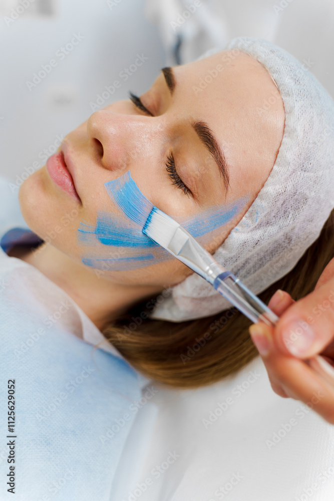 Getting face mask for a women in beauty center. Facial treatment with clay mask. Skincare wellness for female in spa centers. Getting face mask for a women in beauty center. Facial treatment with clay mask. Skincare wellness for female in spa centers.