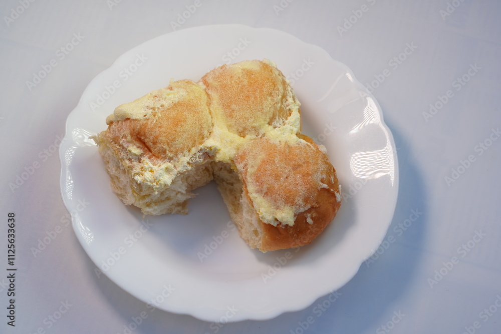Bread rolls spread with butter and sugar Bread rolls spread with butter and sugar