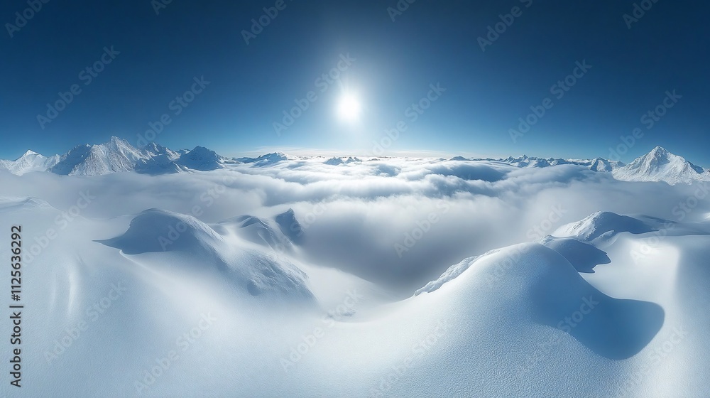 Panoramic view of snow-capped mountains above a sea of clouds under a bright sun. Panoramic view of snow-capped mountains above a sea of clouds under a bright sun.