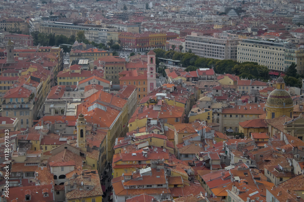 A stunning aerial view of a European cityscape, featuring a sea of terracotta rooftops interspersed with pastel-colored buildings and historic architecture. The image captures the lively atmosphere of A stunning aerial view of a European cityscape, featuring a sea of terracotta rooftops interspersed with pastel-colored buildings and historic architecture. The image captures the lively atmosphere of