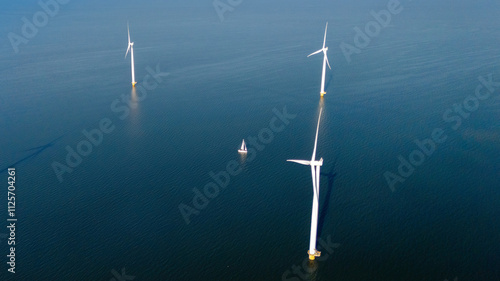 Windmill turbines at sea seen from a drone aerial view from abov photo