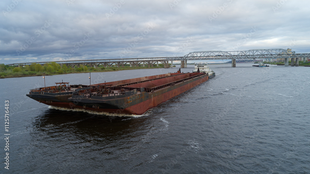 Fototapeta premium Large ship is traveling down a river