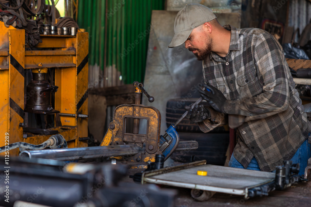 A skilled craftsman diligently working amidst various heavy machinery in an industrial workshop A skilled craftsman diligently working amidst various heavy machinery in an industrial workshop