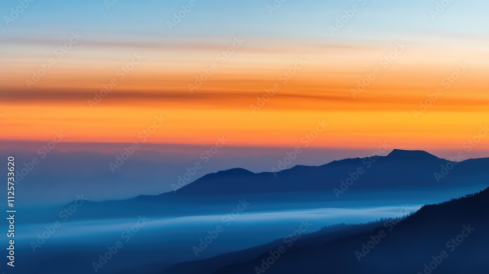 Majestic sunrise over Mount Bromo with a vibrant orange and blue sky creating a serene atmosphere in the golden hour light. Majestic sunrise over Mount Bromo with a vibrant orange and blue sky creating a serene atmosphere in the golden hour light.
