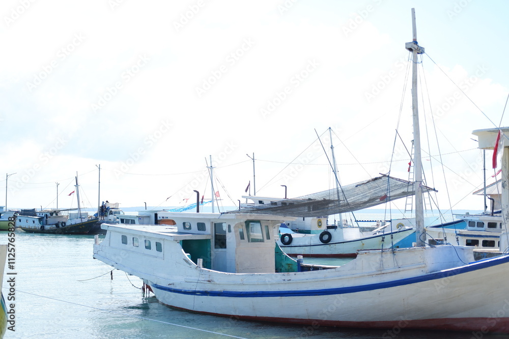 Quiet Beach with Traditional Boat and Clear Blue Waters Quiet Beach with Traditional Boat and Clear Blue Waters
