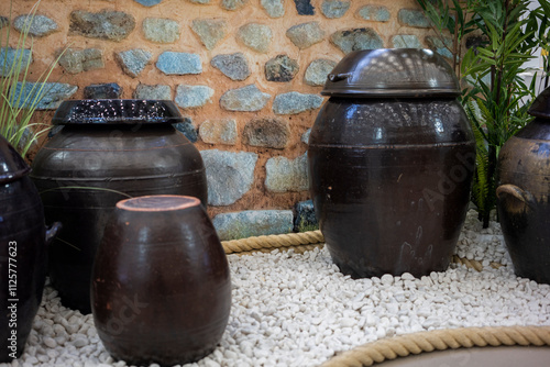 Wallpaper Mural Korean traditional various shapes of ceramic jars, pots in front of traditional wall Torontodigital.ca