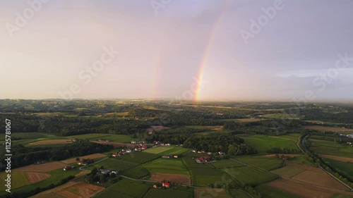 Stunning 4k aerial footage of a drone filming a rainbow in a rural European area. Filmed in Slovenian countryside. Summer. photo