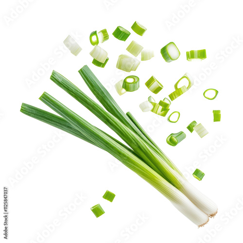Fresh green onions and chopped pieces scattered on a white surface