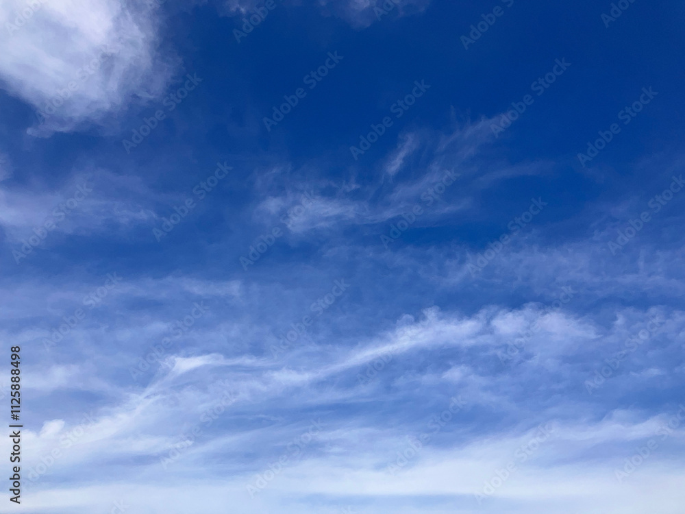Fototapeta premium Serene Azure Skies with Soft, Wispy Clouds - A Tranquil Heaven Above on West Lake in Hanoi, Vietnam