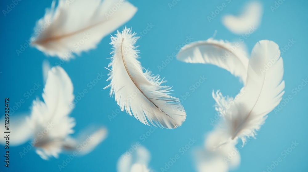Obraz premium 93.A close-up of delicate white feathers drifting softly through a clear blue sky, with each feather appearing weightless and intricate. The feathers seem to be frozen in time, suspended in mid-air