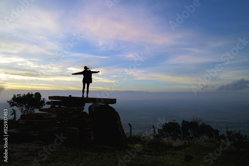 Silhouette of lady on sunrise background on the mountain