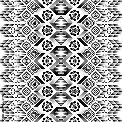 A striking black and white geometric pattern inspired by traditional ethnic art. The design features a repeating motif of diamonds, squares, crosses, and floral elements, creating a bold and graphic l