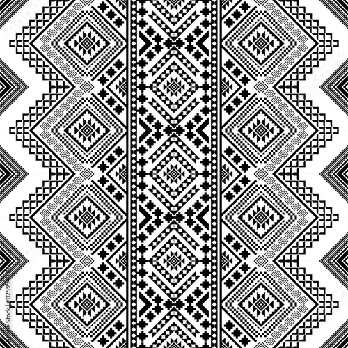 A striking black and white geometric pattern inspired by traditional ethnic art. The design features a repeating motif of diamonds, squares, and crosses, creating a bold and graphic look. 